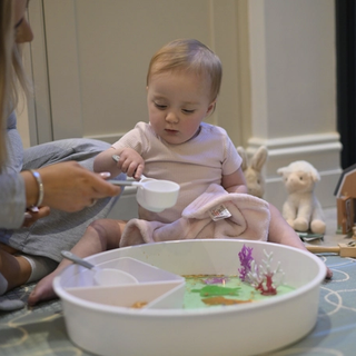 Baby playing with sensory tray