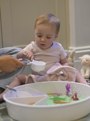 Baby playing with sensory tray