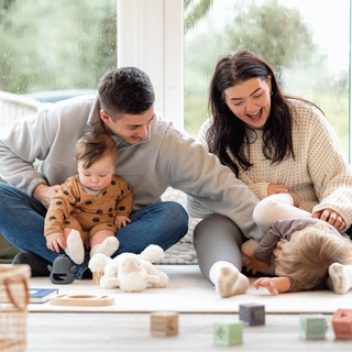 Mum and dad in living room with baby