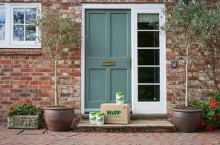 HiPP Organic delivery box placed outside a front door, containing HiPP formula milk