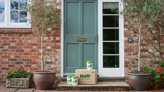HiPP Organic delivery box placed outside a front door, containing HiPP formula milk