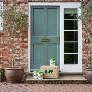 HiPP Organic follow on milks next to a delivery box outside the front door of a house