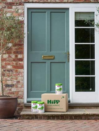 HiPP Organic follow on milks next to a delivery box outside the front door of a house
