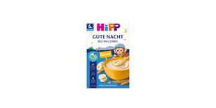 HiPP Gute Nacht Bio Milchbrei Banane Packung mit Schüssel Brei, Bananenscheiben und Getreideähren auf blauem Hintergrund