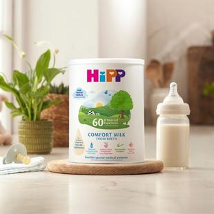 HiPP Organic comfort milk powder tin next to a milk bottle on a kitchen worktop
