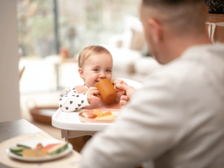 Baby drinking from beaker