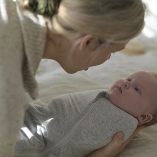 Mum holding baby in swaddle
