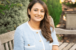 Dr Alia, dermatologist, sat on a park bench