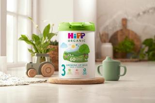 HiPP Organic growing up milk powder tin on a kitchen worktop next to a sippy cup
