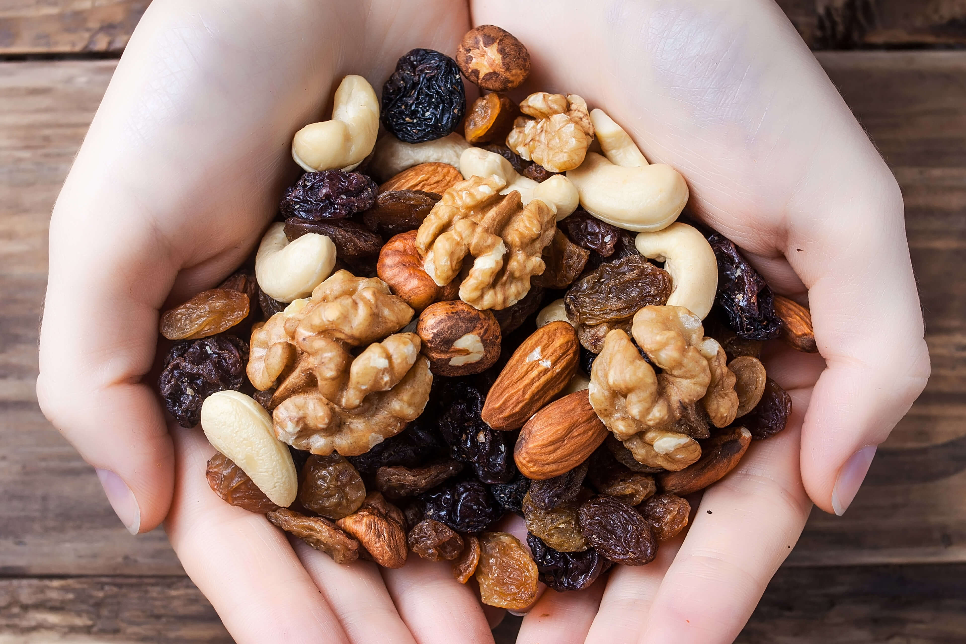 Eine Vielzahl von Nüssen, darunter Mandeln, Walnüsse und Cashews, die auf einem Haufen angeordnet sind.