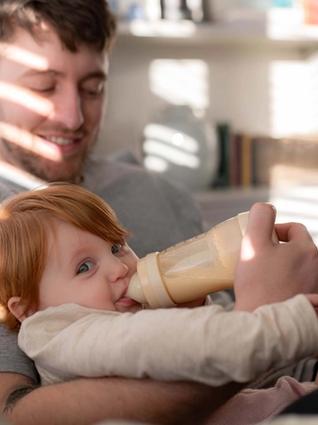 Dad bottle feeding baby