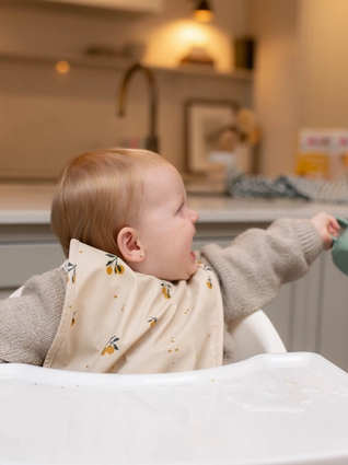 Visibly upset toddler in highchair