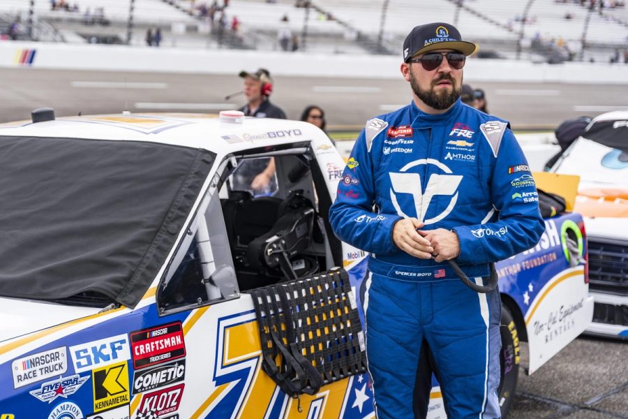 Spencer Boyd beside the No. 76 truck