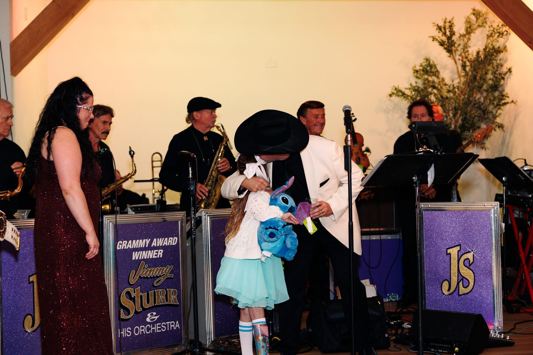 A wish child receives a gift on stage with Jimmy Sturr and his orchestra