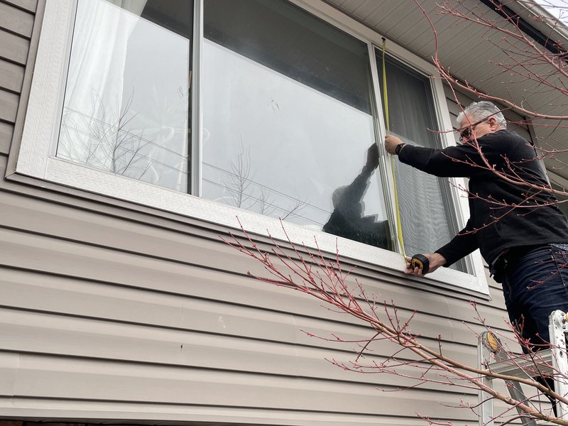 Second-story dual-pane vinyl window replacement on a residential home