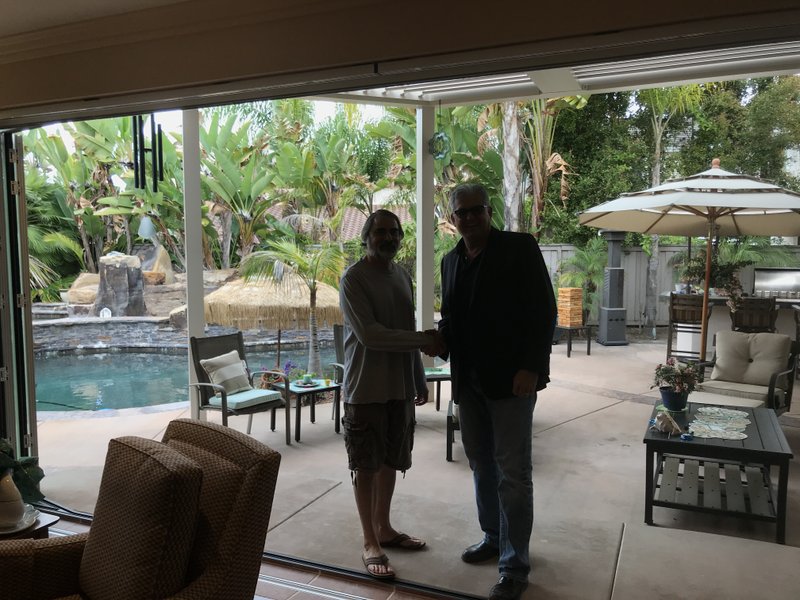 Drew Guthrie congratulating a homeowner at the close-out of a multi-panel folding glass door installation in a Wine Country pool home