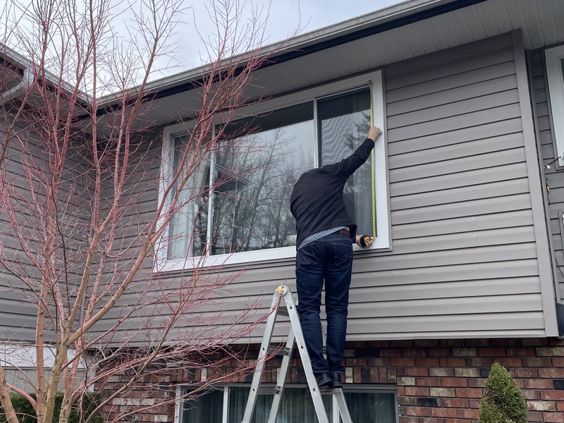 Dual-pane vinyl window frame detail during install