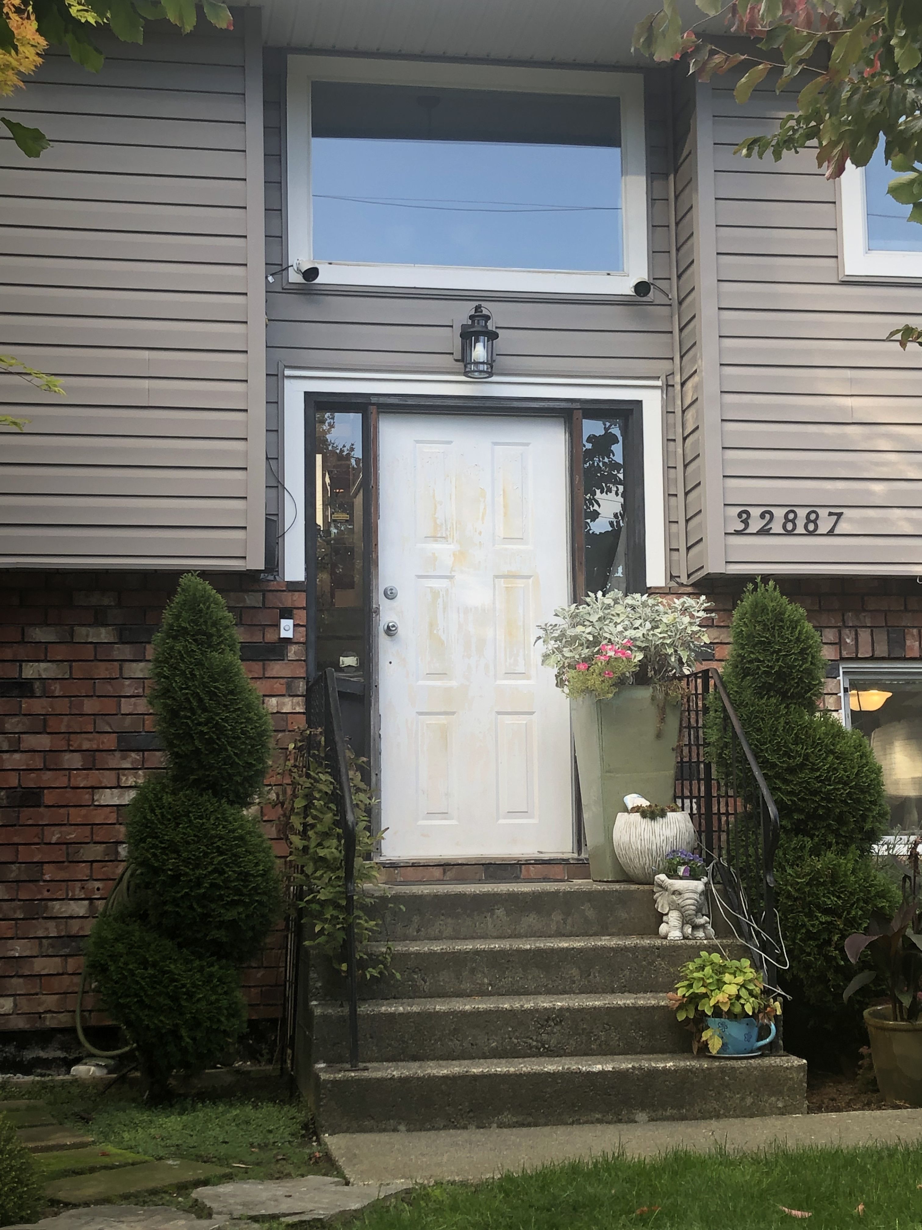 Fiberglass entry door replacement with transom window on a two-story home
