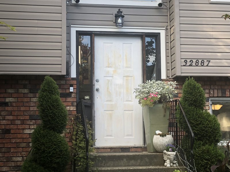 Fiberglass entry door replacement with transom window on a two-story home