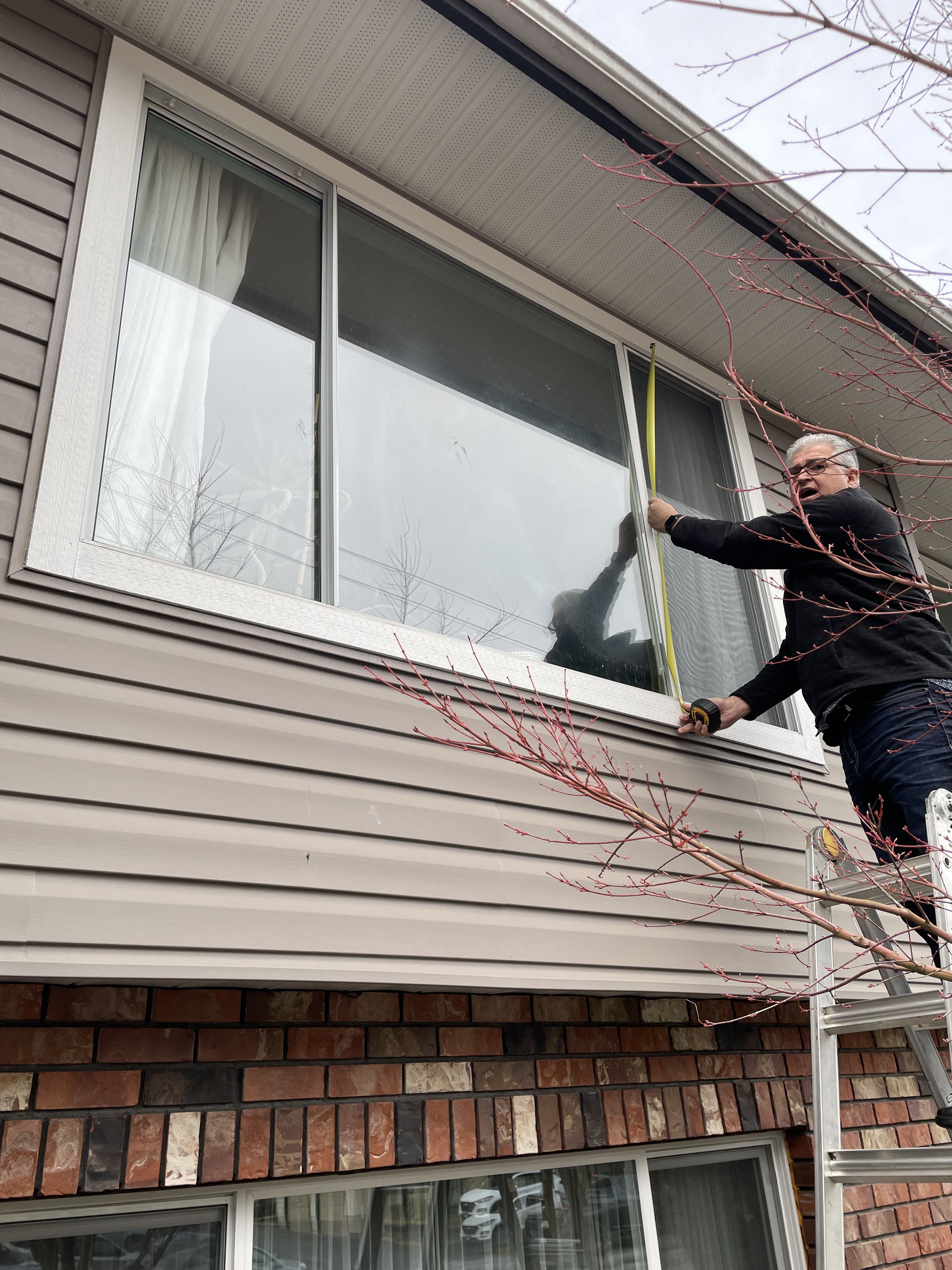 Close-up of a dual-pane vinyl window replacement install