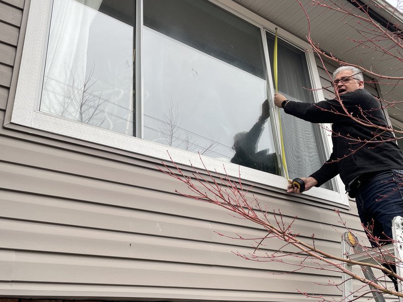 Close-up of a dual-pane vinyl window replacement install