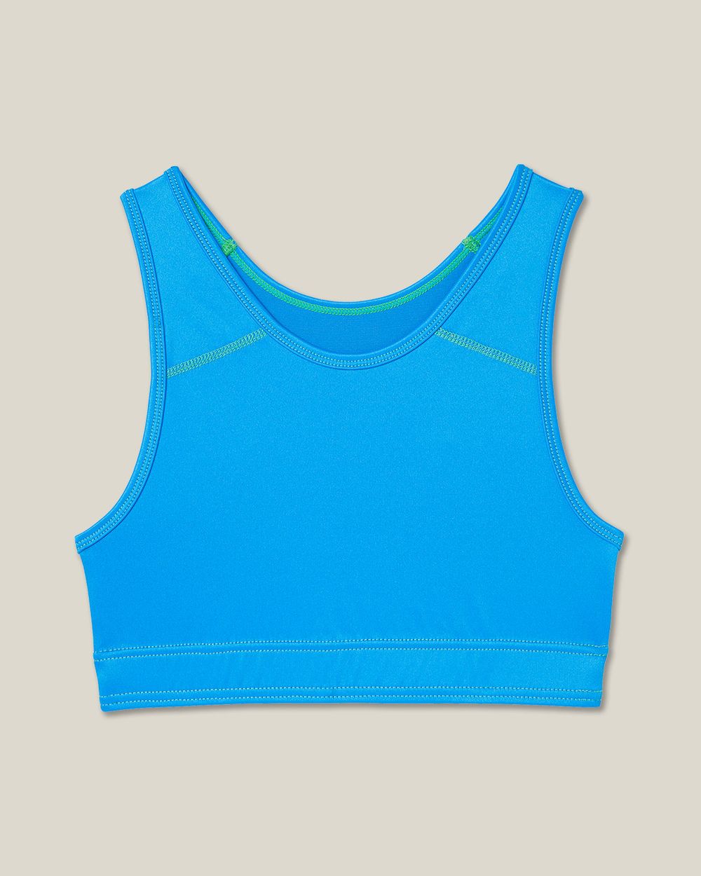 Sport-bh i en klar aquablå färg med enkel design och breda axelband. Gjord för att ge stöd och komfort vid träning.