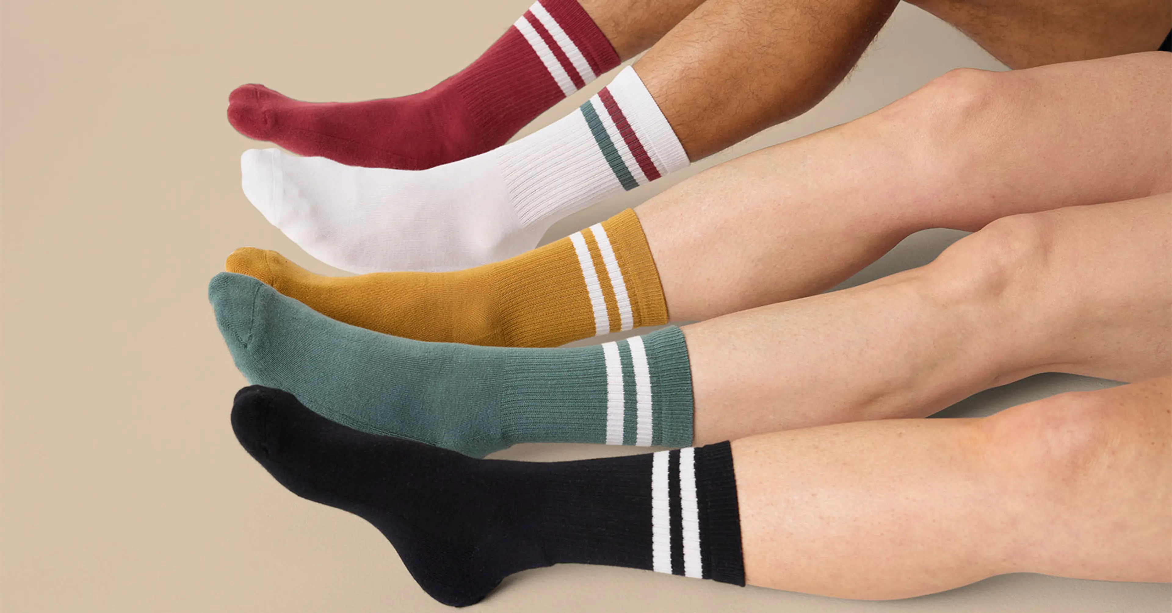 Fem par sportstrumpor i olika färger med ribbad struktur och två ränder vid öppningen, i rött, vitt, senapsgult, grönt och svart.