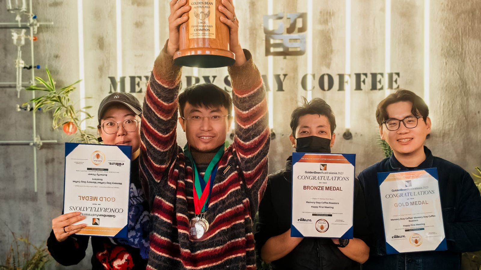 Memory Stay Coffee team with their 2023 Golden Bean medals and certificates