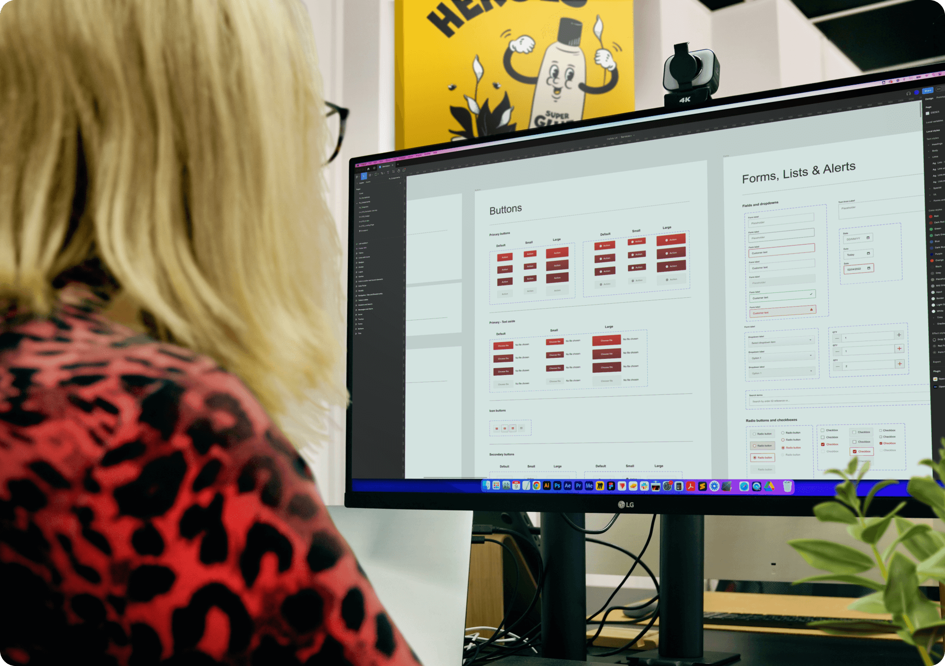 Image showing a Glue employee looking at her computer screen. The screen shows a Figma file with a design system