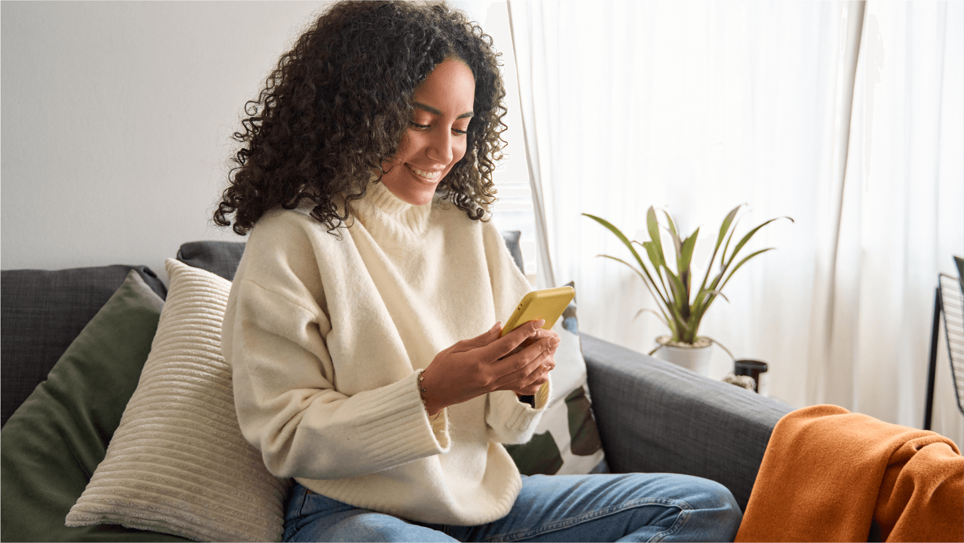 Woman looking at her phone at home
