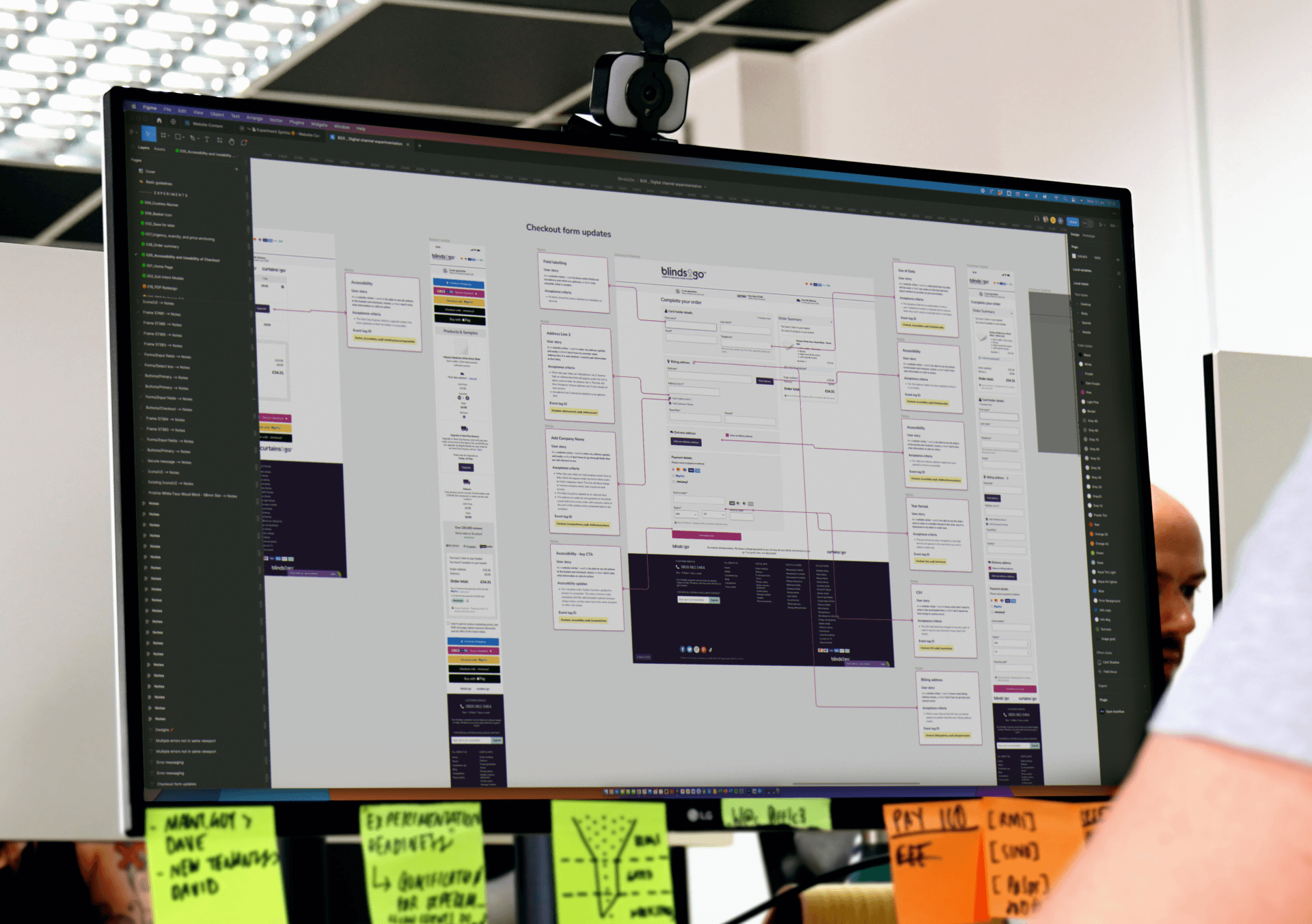A picture of a Glue designer sitting in front of his display showcasing a website being designed and annotated.