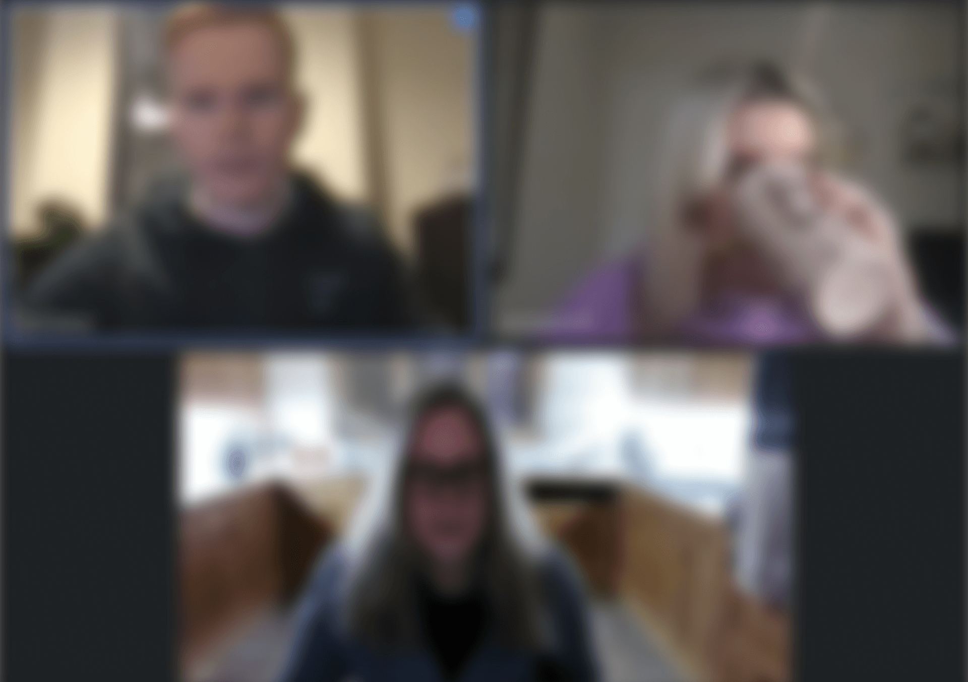 A blurred image of three people on a teams call