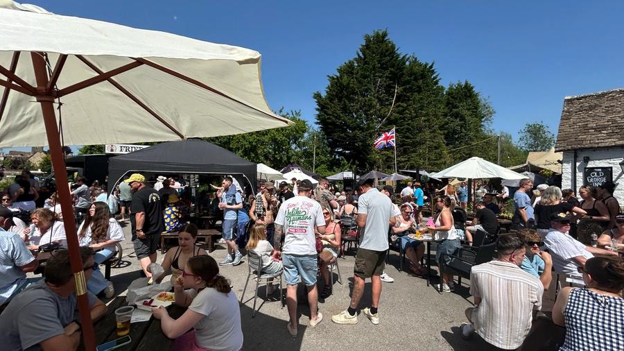 Food stalls and busy pub tables at South Cerney Street Fair
