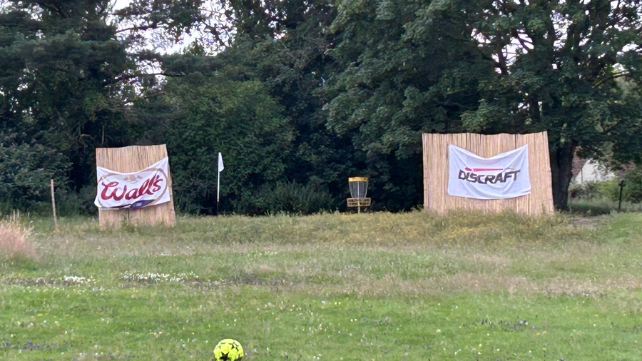 Disc golf basket and footballs on the shared course at Cricklade House
