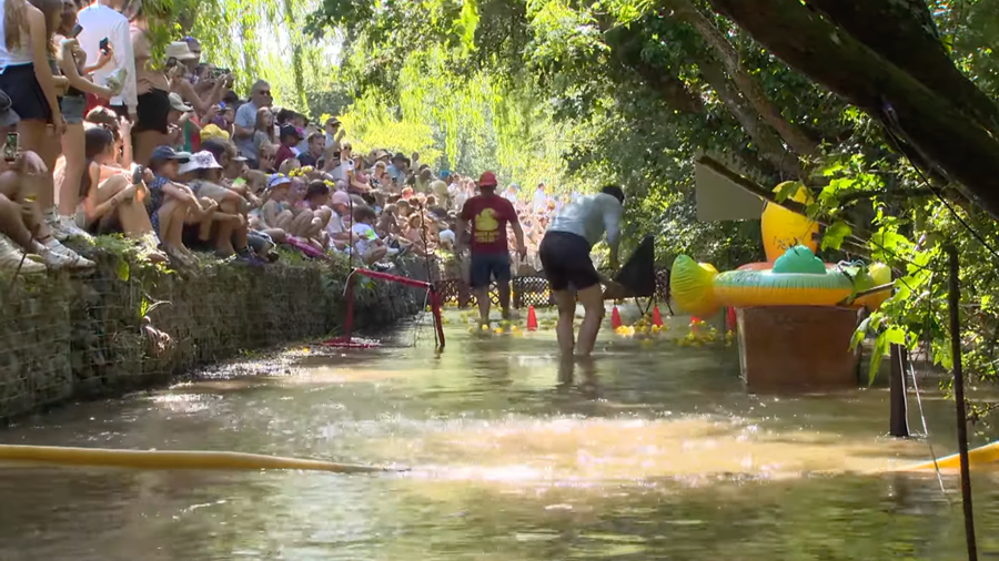 The MC commentating from the water during the duck race