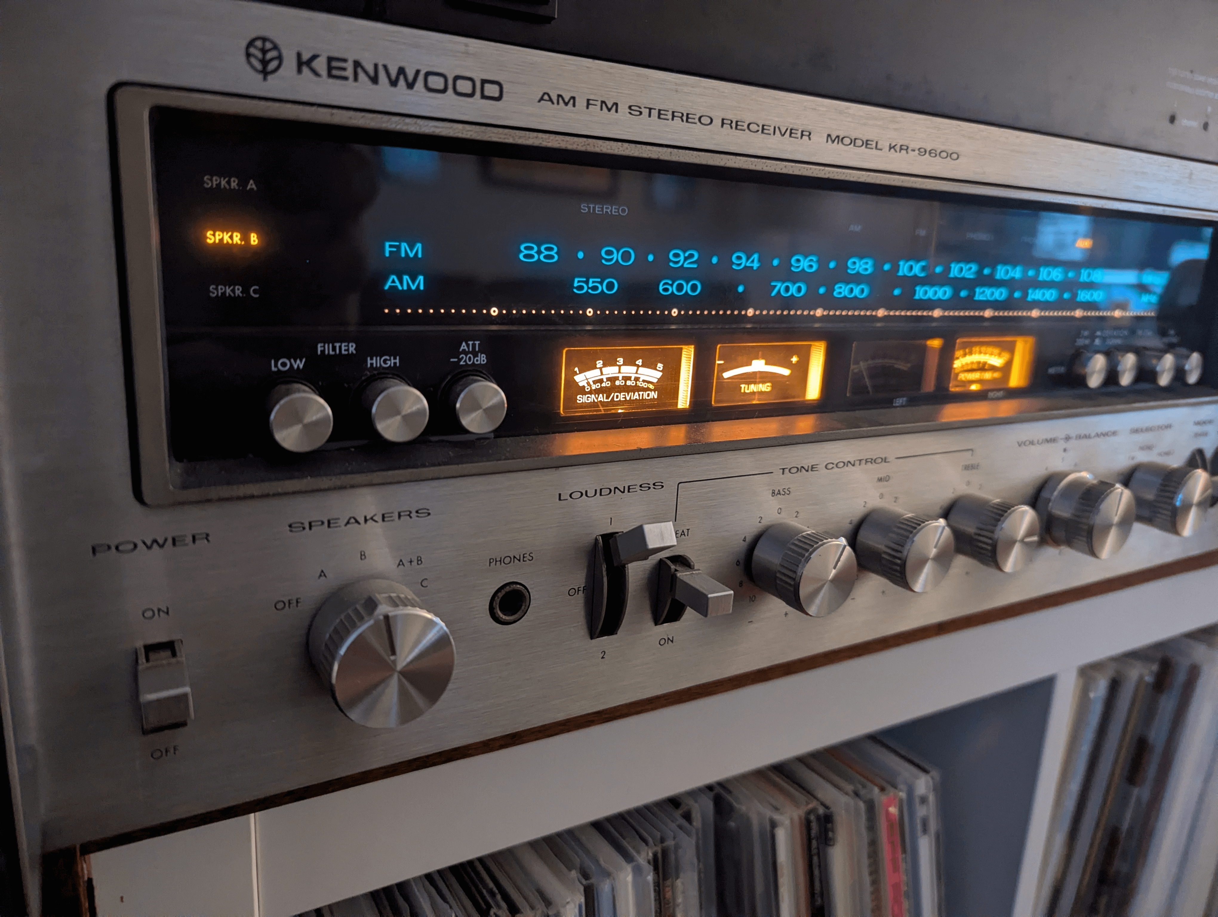 Front view of a 1970s kenwood silver faced receiver lights glowing