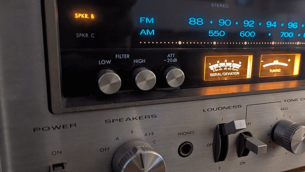 Front view of a 1970s kenwood silver faced receiver lights glowing