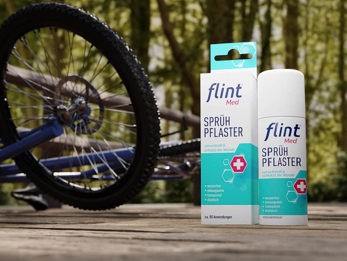 Still aus dem Flintmed-Werbefilm: Verpackung des flint Med Sprühpflasters neben einem Fahrradreifen