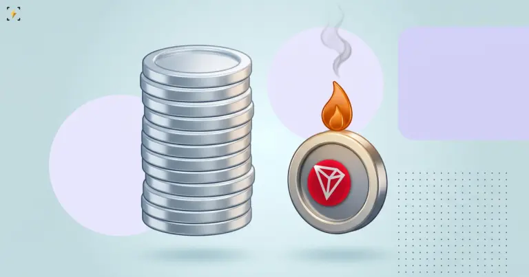 A tall stack of blank silver coins beside a single Tron coin with a small flame burning on its rim