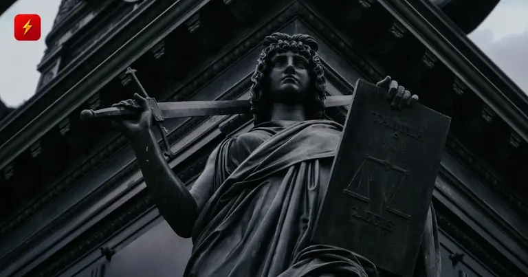 Statue of justice with a sword and law tablet
