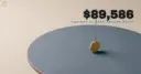 A tiny coin on edge balancing a tall needle on a vast smooth slate-blue disc