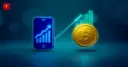 A smartphone with a rising chart next to a gold bitcoin coin, symbolizing Gen Z's growing investment activity