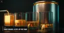 Four glass tanks of liquid gold with three widening drains beside a large full steel vault