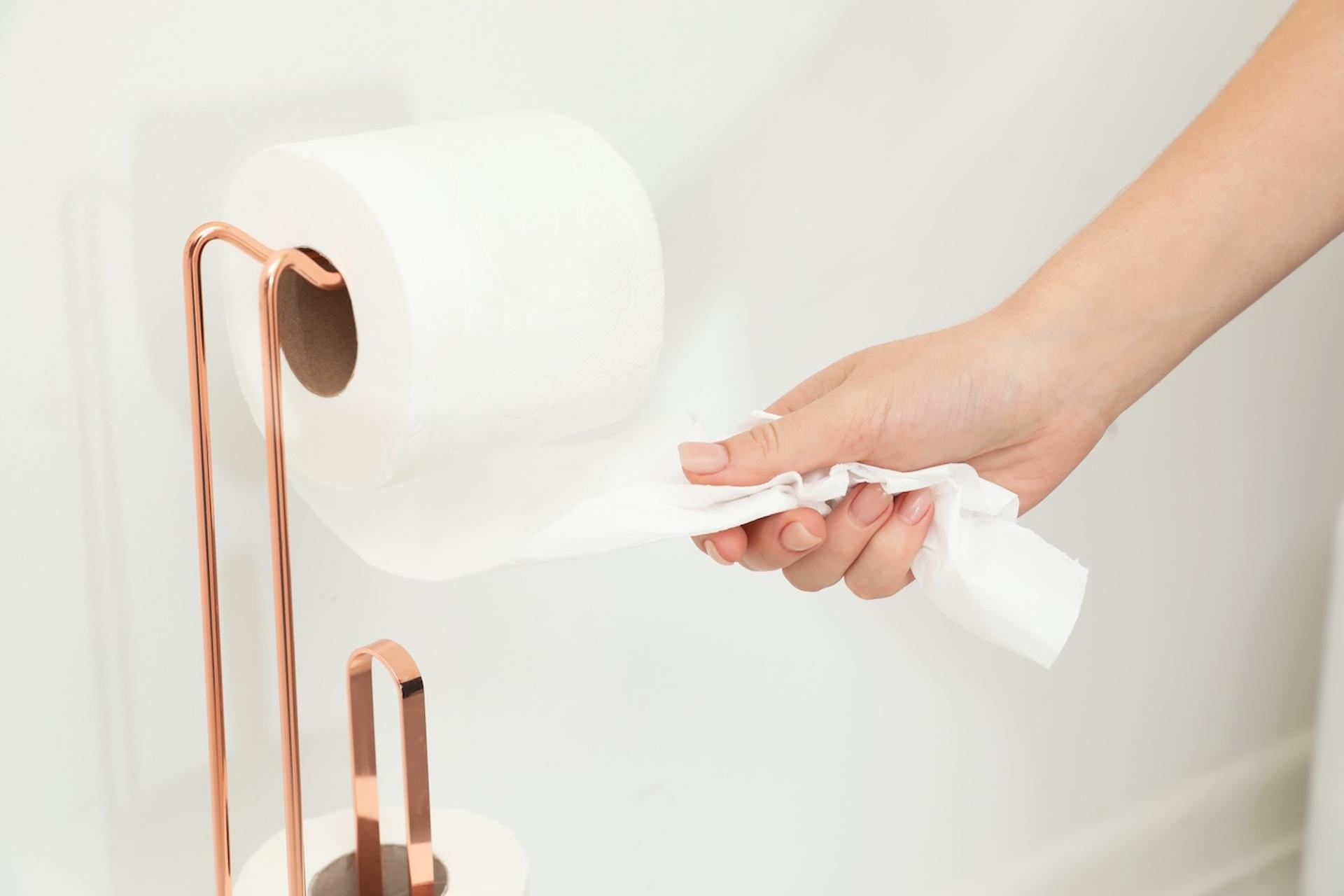 Hand pulling toilet paper