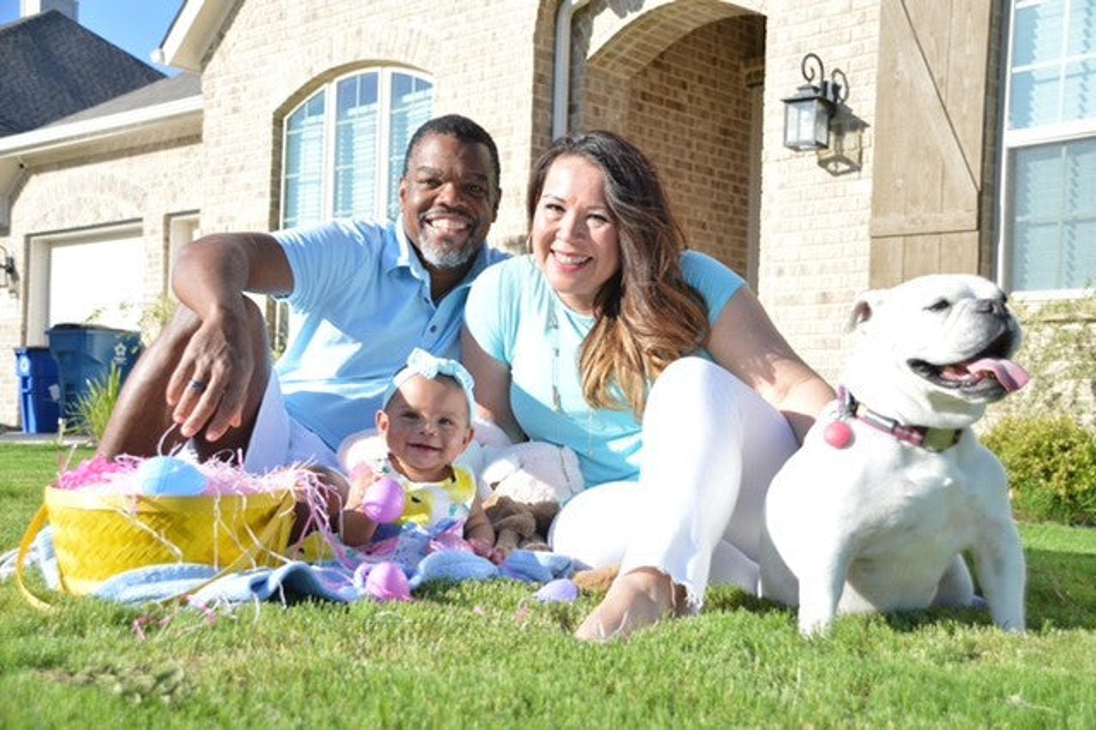 SNOO review: Mom, dad, baby, and dog posing for a picture outside