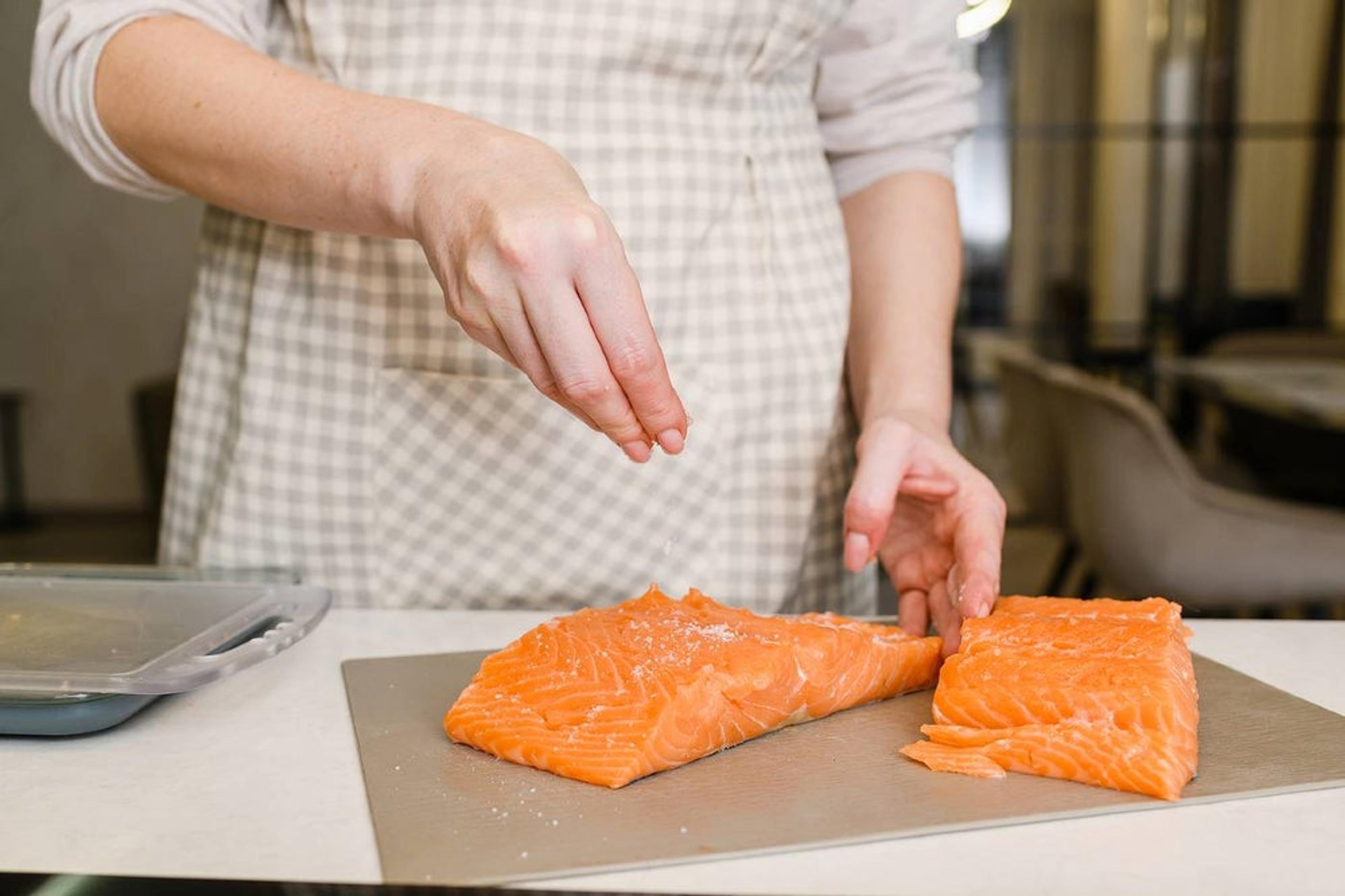 Pregnant woman preparing fish