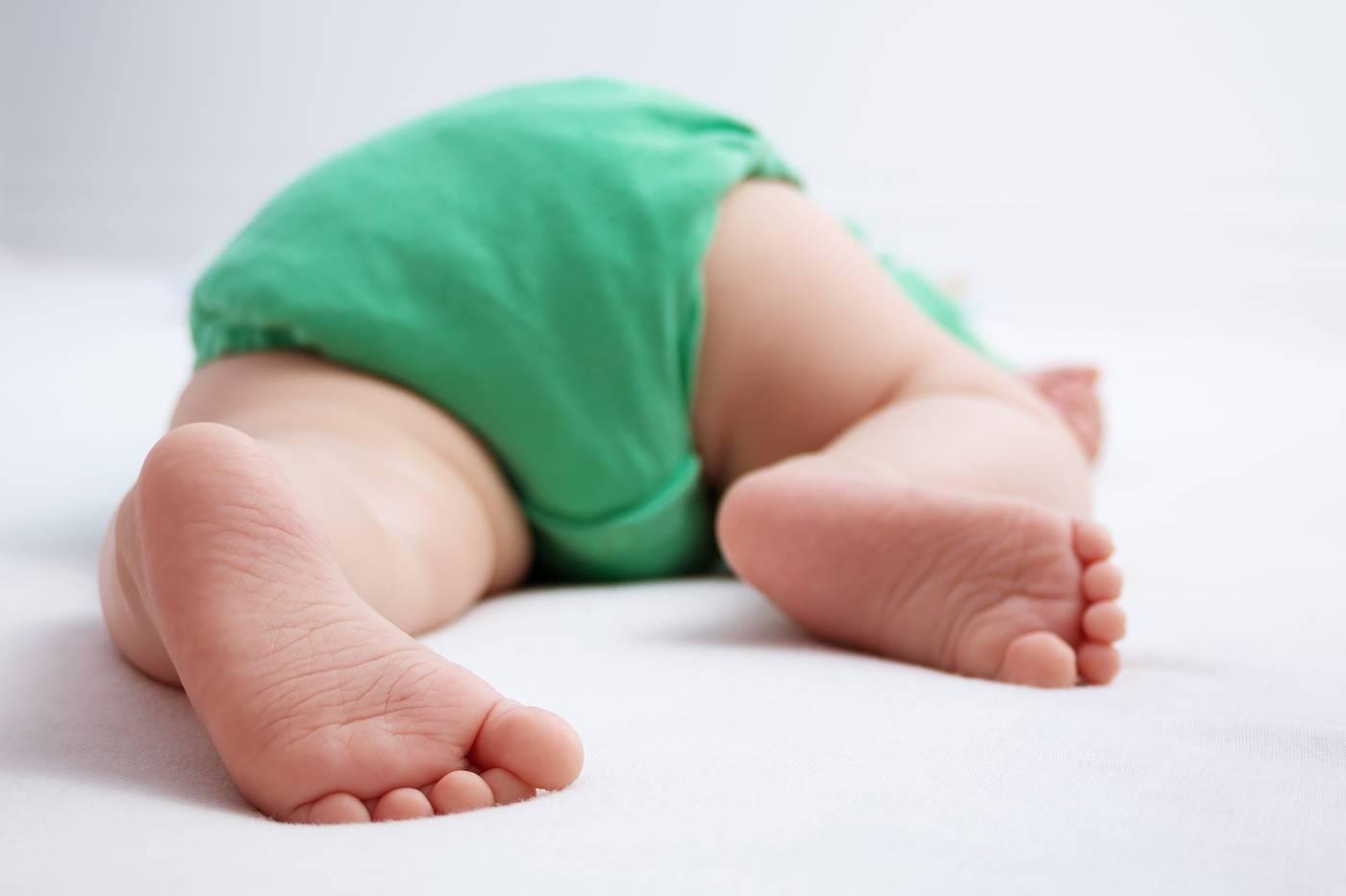 Rear view of baby sleeping on stomach
