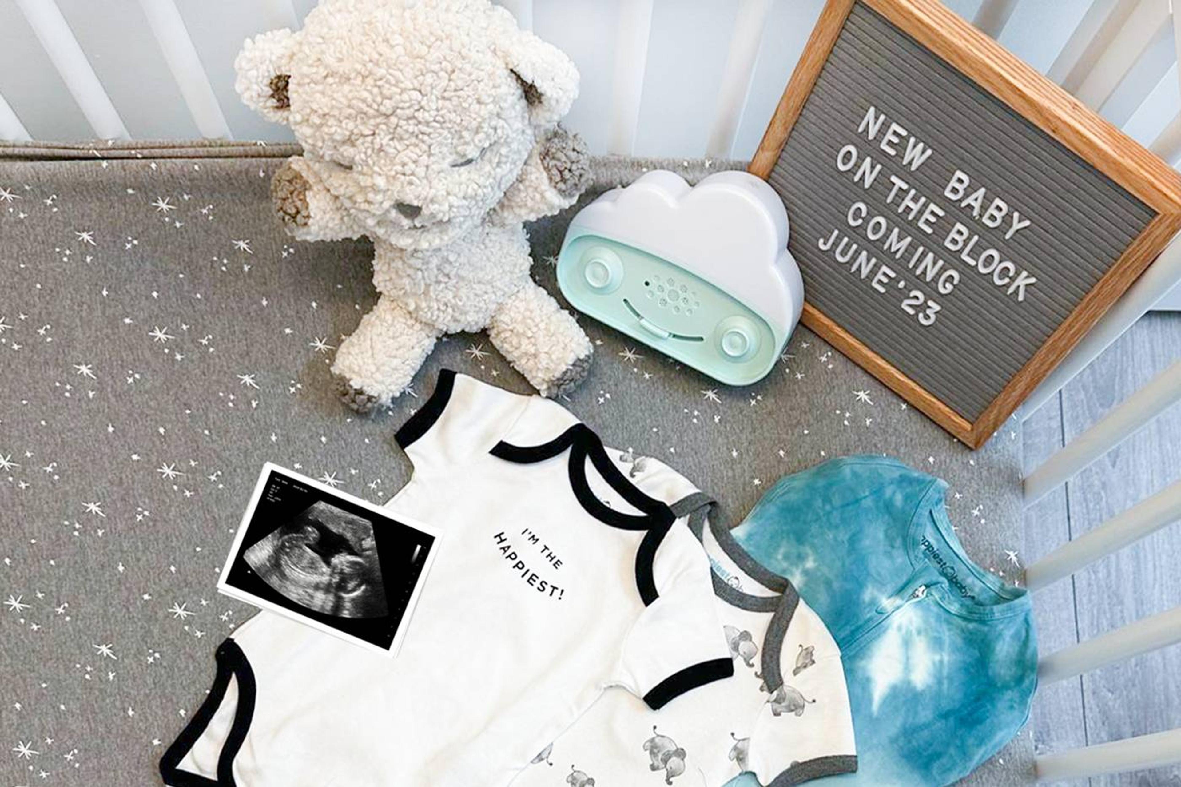 Pregnancy announcement w/ SNOObie, SNOObear, and letterboard that reads "New baby on the block coming June '23""