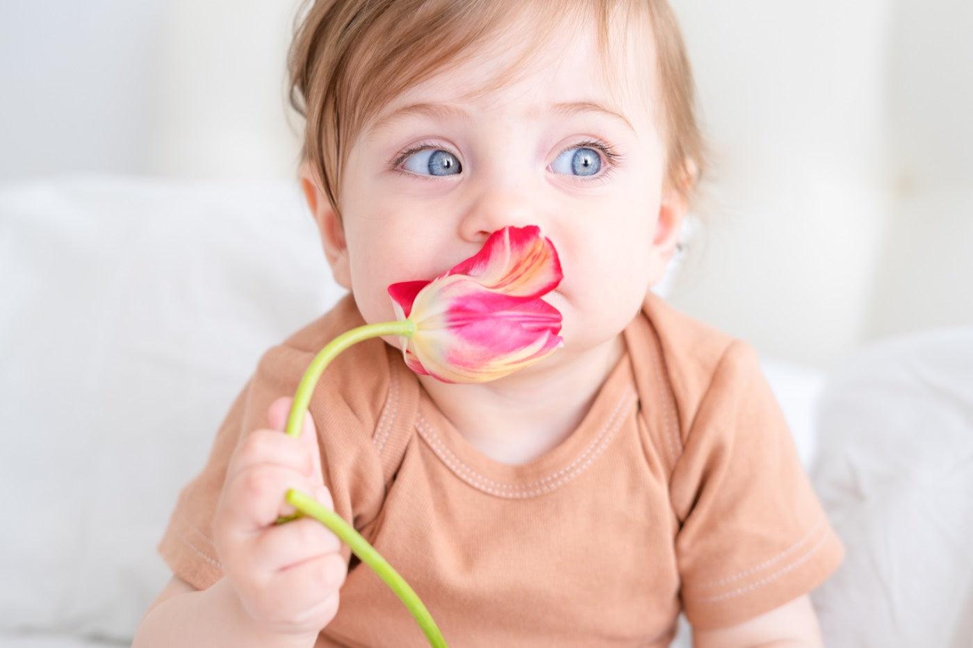 baby holding a flower: flower and plant baby names