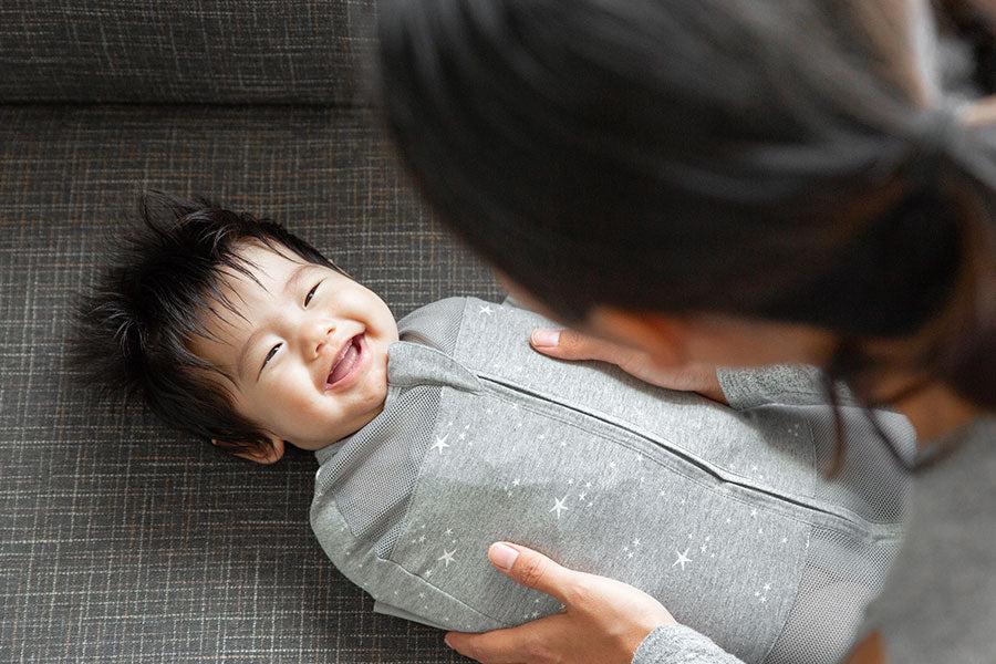 smiling baby in a swaddle